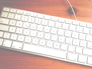 Weiß-silberne Tastatur auf Holztisch (Foto: Birte Vogel)